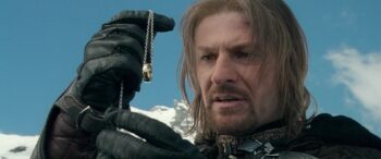 Movie Boromir (Sean Bean) examines the One Ring in "The Lord of the Rings: The Fellowship of the Ring" (2001)
